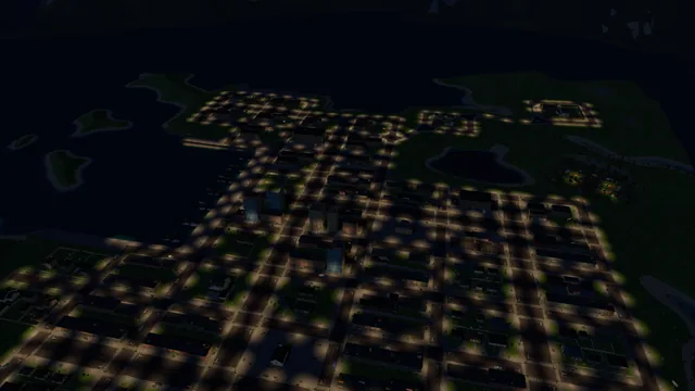 The whole town from high above at night, every street lit by pools of lamplight